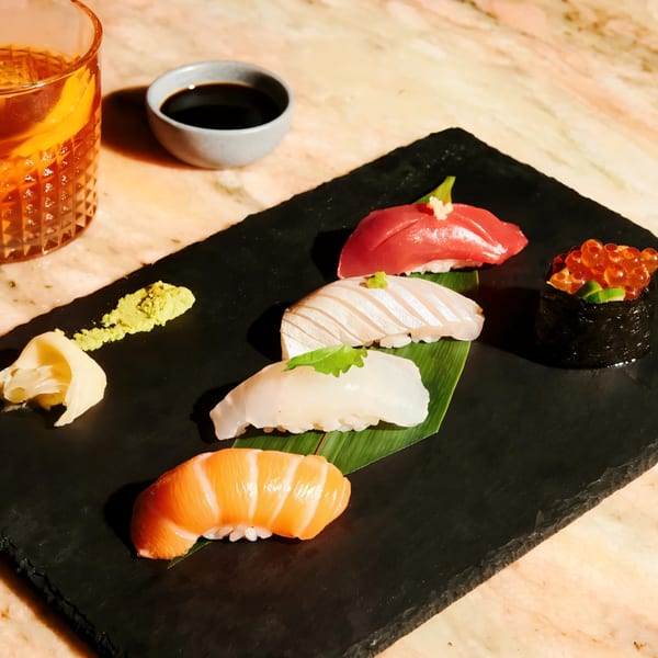 Assorted Sapps Nyc sushi and sashimi, including salmon, tuna, and roe, with wasabi and ginger.